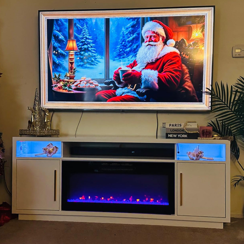 Television displaying Santa Claus on white fireplace TV stand