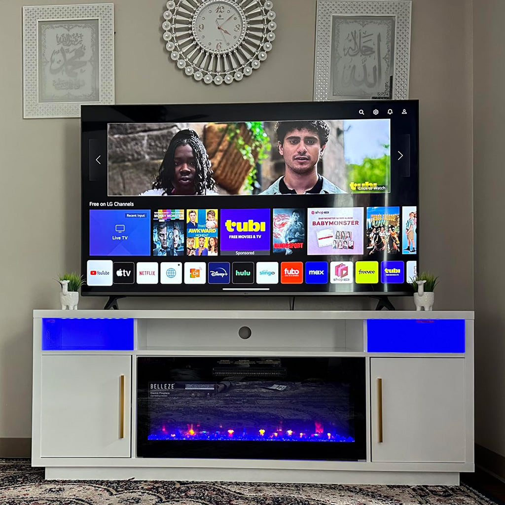 The TV is playing on the white fireplace TV stand