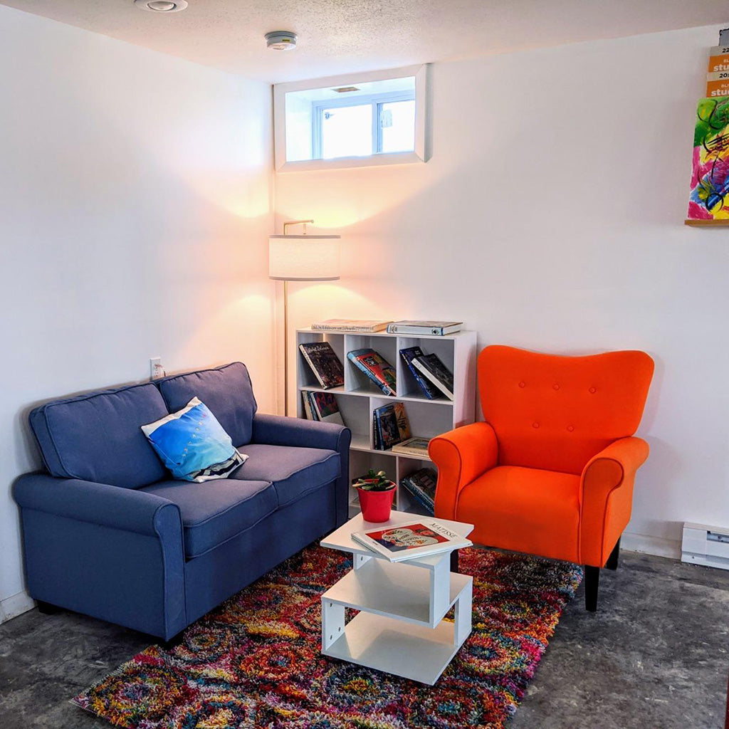 Orange chair and blue sofa